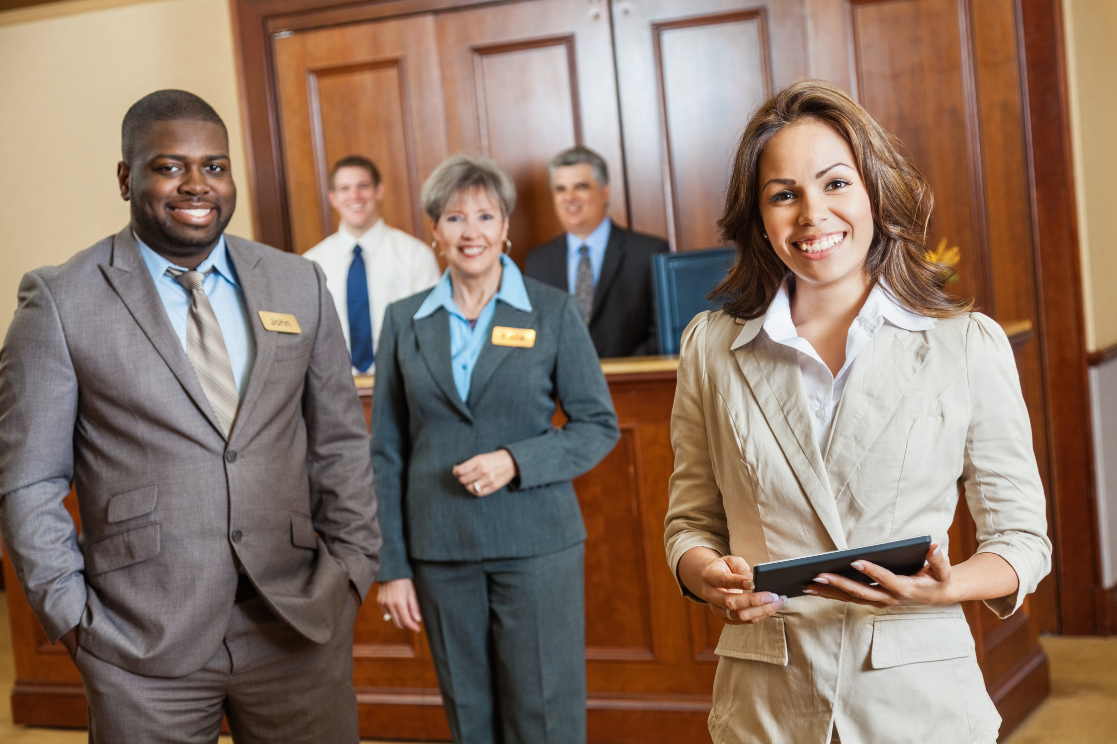Friendly professional hotel staff with managers, clerks, and administrators